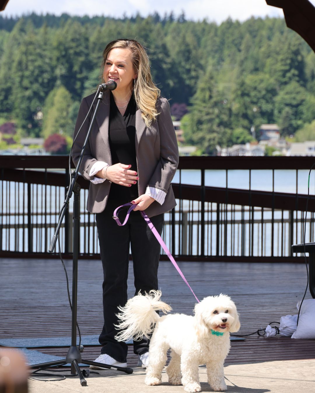Tarra with her service dog, Hope, speaking in front of the waterfront